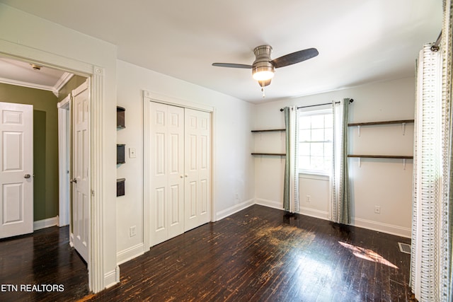 unfurnished bedroom with baseboards, ceiling fan, a closet, and wood-type flooring