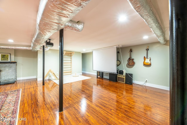 finished basement with baseboards, recessed lighting, and wood finished floors