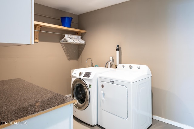 laundry room with washer and clothes dryer, laundry area, and baseboards