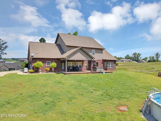 1810 Griffitts Mill Cir, Maryville, TN 37803 - back of property featuring a hot tub, a lawn, a patio, and roof with shingles