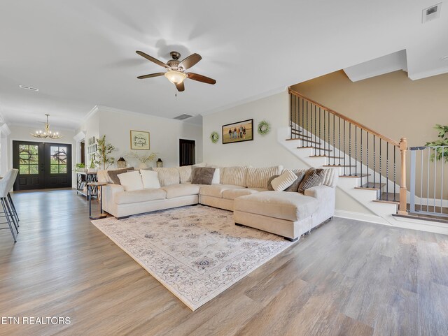1810 Griffitts Mill Cir, Maryville, TN 37803 - living area featuring ornamental molding, wood finished floors, stairway, a chandelier, and a ceiling fan