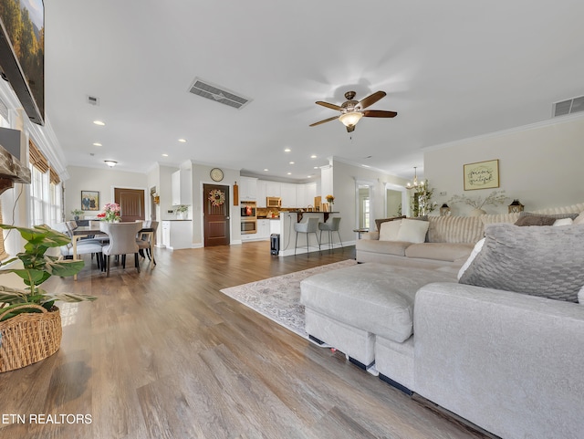 1810 Griffitts Mill Cir, Maryville, TN 37803 - living room with crown molding, a ceiling fan, wood finished floors, recessed lighting, and a chandelier