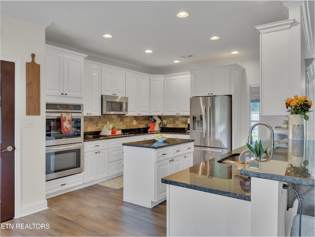 1810 Griffitts Mill Cir, Maryville, TN 37803 - kitchen featuring appliances with stainless steel finishes, a sink, wood finished floors, backsplash, and white cabinets