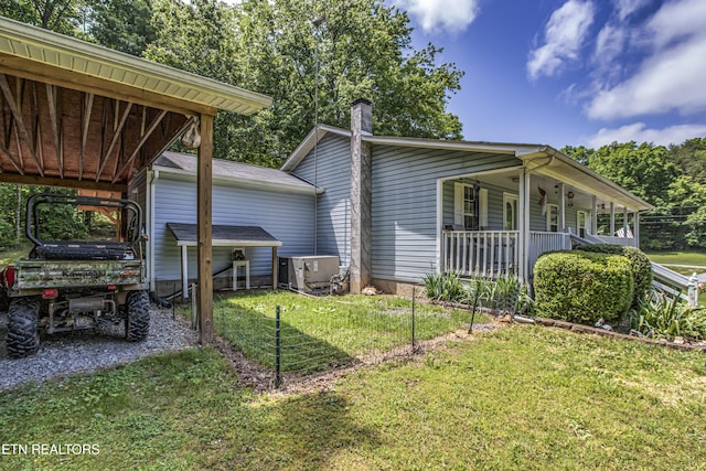 325 Correll Ridge Rd, Decatur, TN 37322 - view of property exterior with a lawn, covered porch, a carport, and a chimney