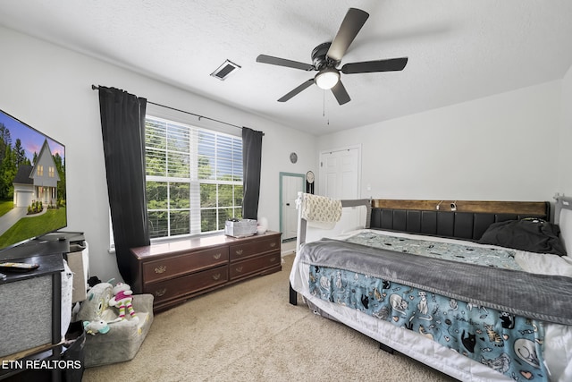 bedroom featuring a ceiling fan, light carpet, and visible vents