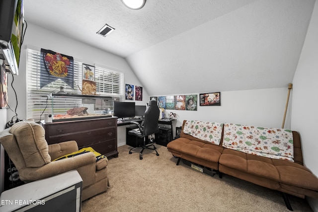 home office with lofted ceiling, carpet, a textured ceiling, and visible vents
