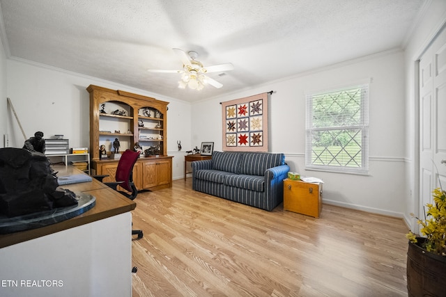 office with light wood finished floors, ornamental molding, a textured ceiling, and ceiling fan
