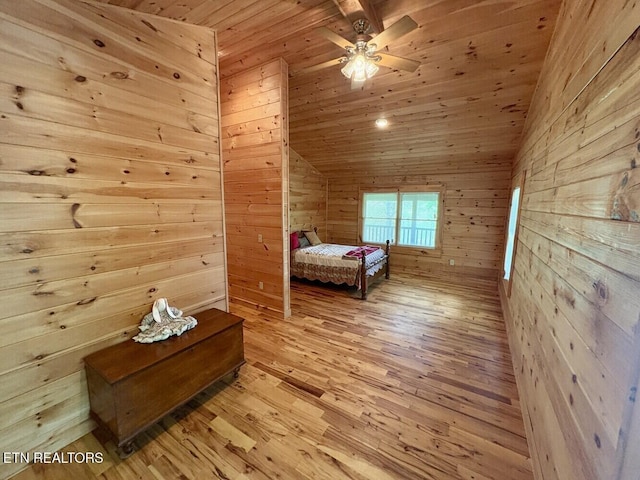 bedroom featuring light wood finished floors, wood walls, and wood ceiling