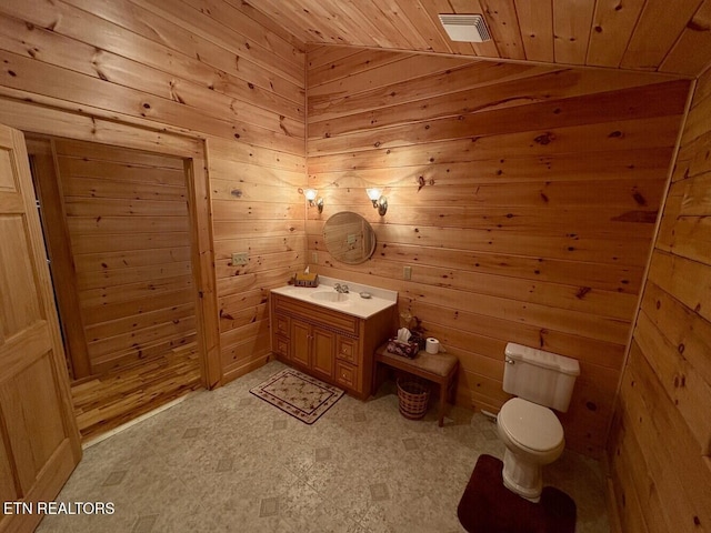 bathroom featuring toilet, vanity, tile patterned floors, wooden ceiling, and wooden walls