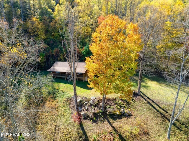bird's eye view with a wooded view
