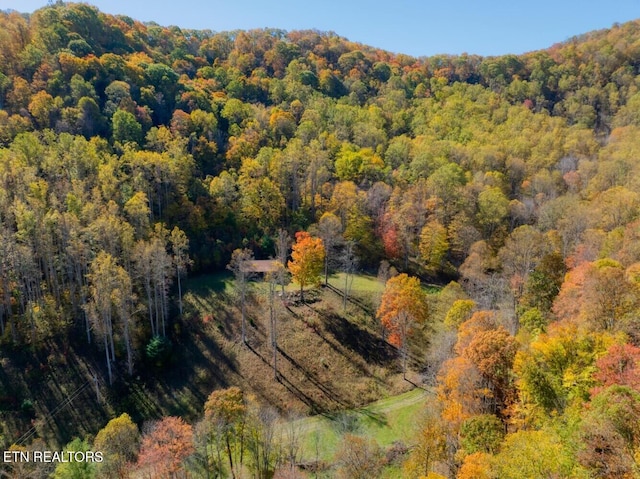 birds eye view of property with a wooded view