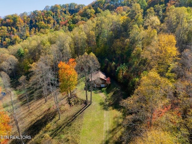 drone / aerial view featuring a view of trees