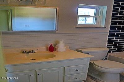 full bathroom with toilet, vanity, and shower / tub combination