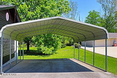 view of parking / parking lot featuring a detached carport and aphalt driveway
