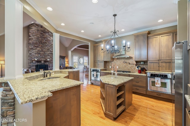 205 Melea Ln, Kingston, TN 37763 - kitchen featuring stainless steel appliances, a kitchen island with sink, arched walkways, open shelves, and a sink