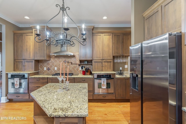205 Melea Ln, Kingston, TN 37763 - kitchen with appliances with stainless steel finishes, a chandelier, light wood-style flooring, ornamental molding, and brown cabinets