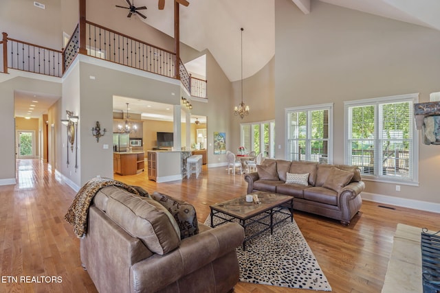 205 Melea Ln, Kingston, TN 37763 - living area featuring a chandelier, ceiling fan, high vaulted ceiling, and light wood finished floors