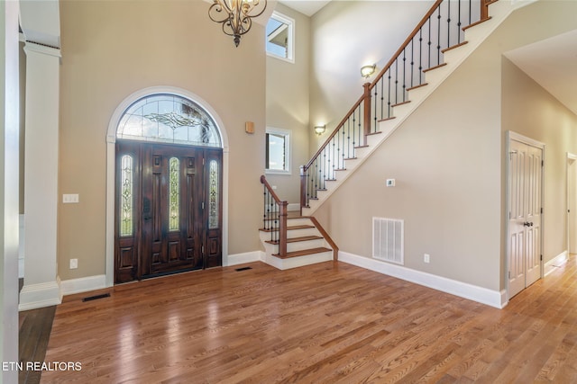 205 Melea Ln, Kingston, TN 37763 - entrance foyer with plenty of natural light, wood finished floors, a towering ceiling, stairway, and a chandelier