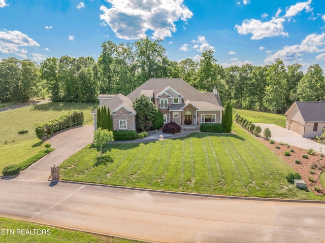 205 Melea Ln, Kingston, TN 37763 - traditional-style home with a chimney, driveway, a front yard, and stone siding