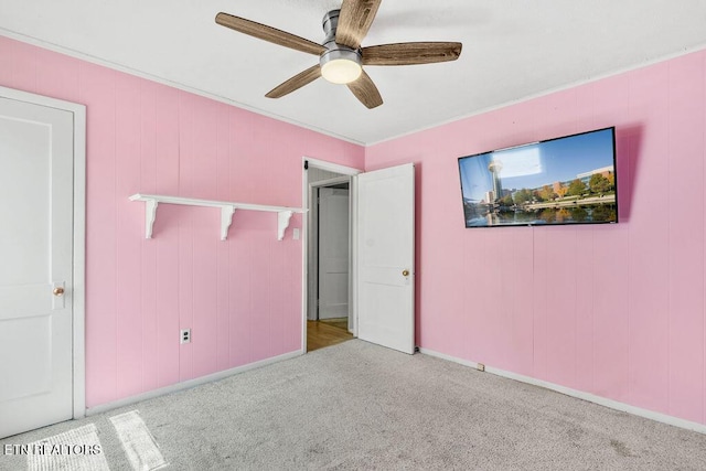 unfurnished bedroom with a ceiling fan, baseboards, and carpet floors
