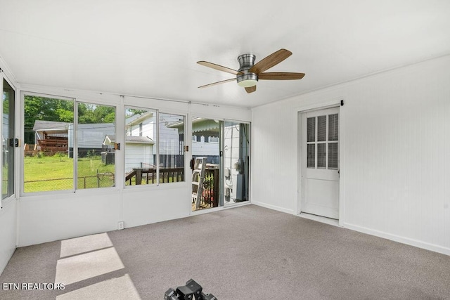 unfurnished sunroom with a ceiling fan