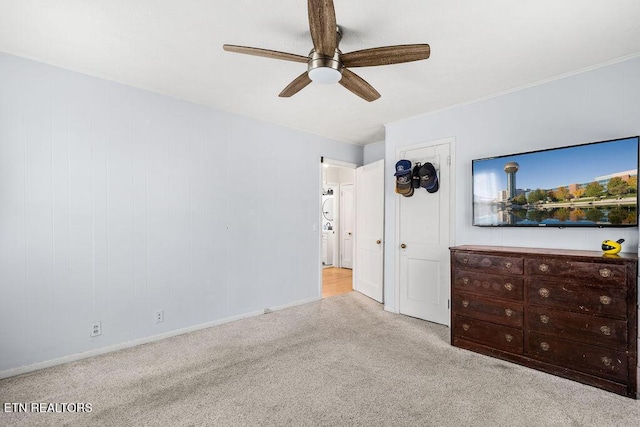 unfurnished bedroom featuring carpet, baseboards, and a ceiling fan