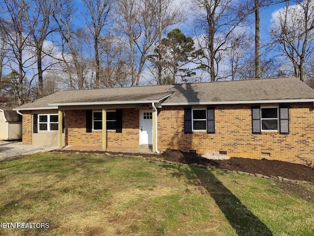 ranch-style home featuring roof with shingles, a front lawn, brick siding, and crawl space