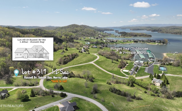 birds eye view of property with a water and mountain view