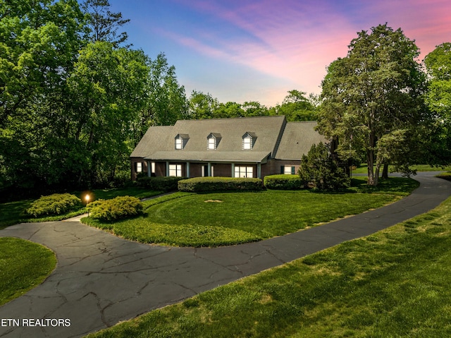 new england style home featuring a front yard