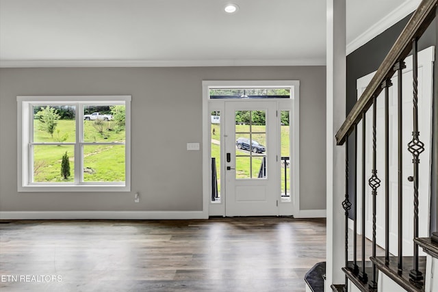 entrance foyer with stairs, crown molding, dark wood finished floors, baseboards, and recessed lighting