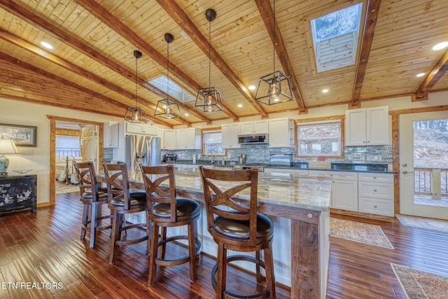 1898 Kennedy Way, Del Rio, TN 37727 - kitchen with appliances with stainless steel finishes, white cabinetry, plenty of natural light, wooden ceiling, and beam ceiling