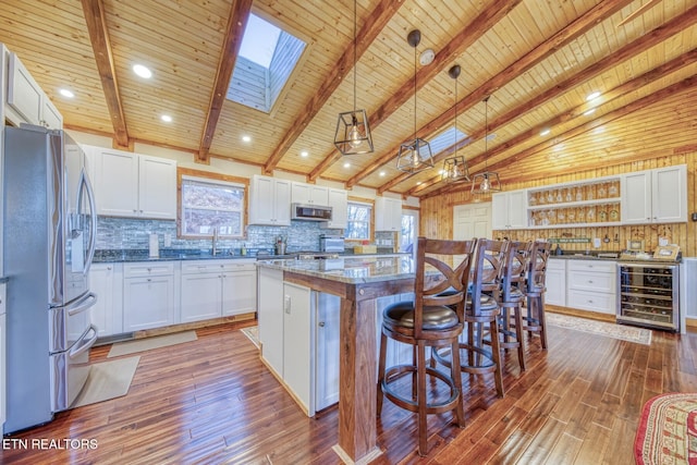 1898 Kennedy Way, Del Rio, TN 37727 - kitchen with appliances with stainless steel finishes, beverage cooler, open shelves, hardwood / wood-style flooring, and a center island