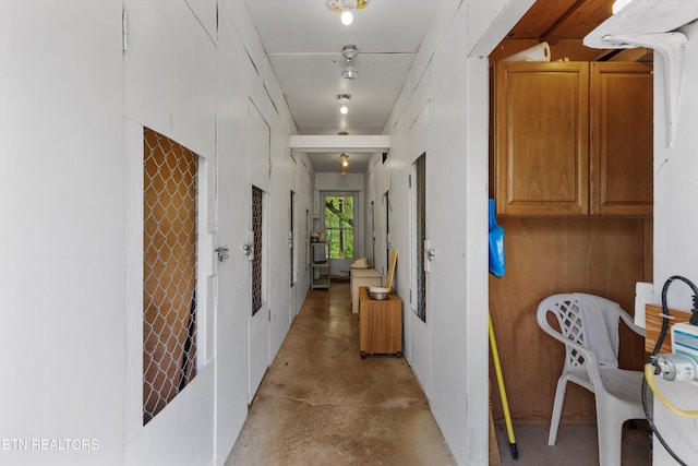 hallway with concrete flooring
