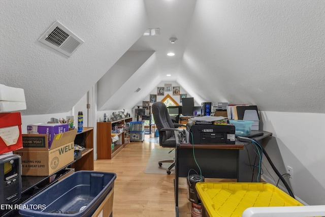 office area with lofted ceiling and wood finished floors