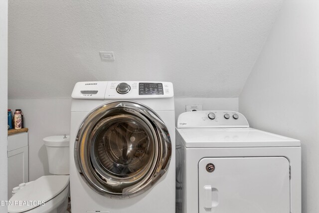 washroom featuring independent washer and dryer and a textured ceiling