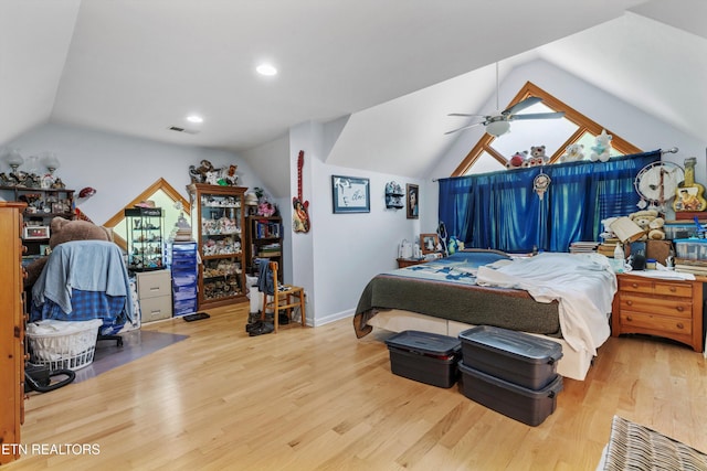 bedroom with lofted ceiling, wood finished floors, and baseboards