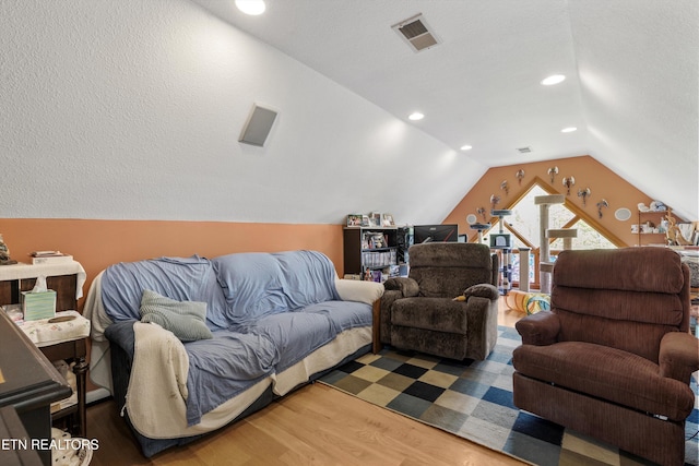 living area with lofted ceiling, wood finished floors, and recessed lighting