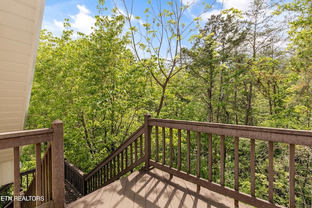 wooden deck with a view of trees