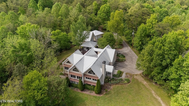 view from above of property featuring a heavily wooded area