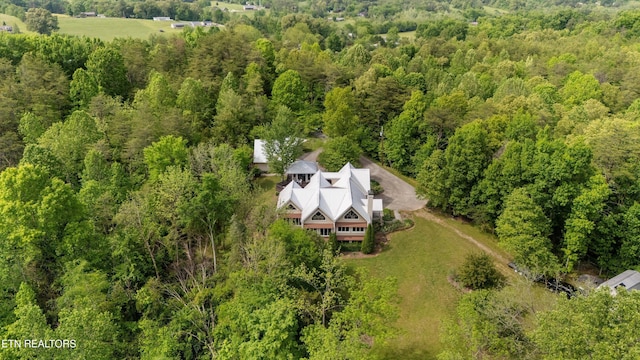 view of subject property featuring a heavily wooded area