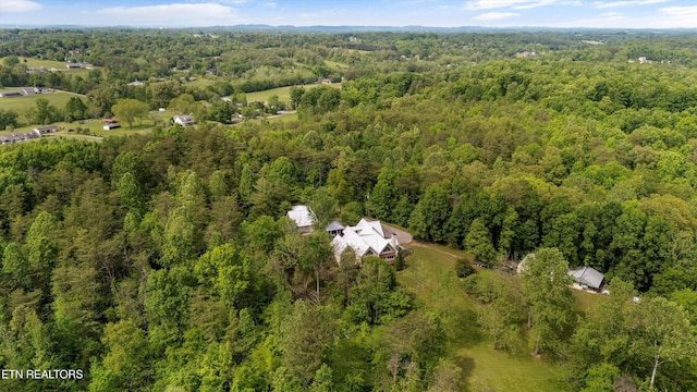 aerial view of property's location with a heavily wooded area