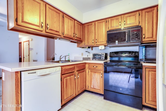 375 Rainbow Rd, Sevierville, TN 37862 - kitchen with light floors, a toaster, a sink, black appliances, and light countertops