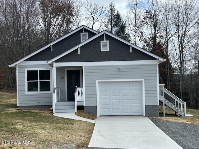 view of front facade featuring concrete driveway, a garage, and a front lawn