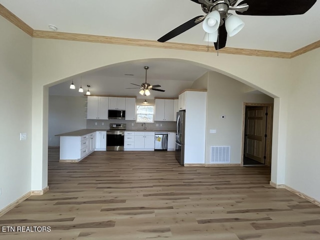 kitchen with ceiling fan, stainless steel appliances, arched walkways, and visible vents