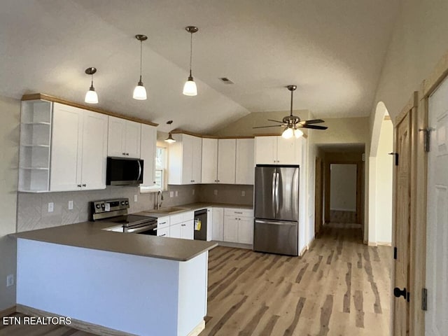 kitchen with a peninsula, stainless steel appliances, open shelves, vaulted ceiling, and backsplash