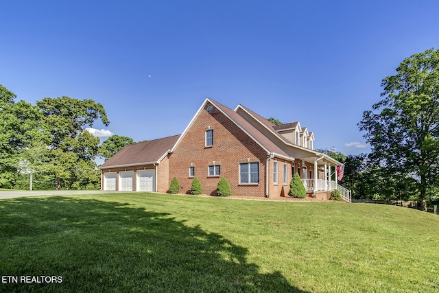 2000 Robinson Dr, Lenoir City, TN 37772 - view of front of home featuring brick siding, a front lawn, covered porch, and a garage