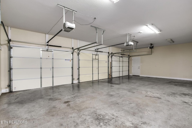 2000 Robinson Dr, Lenoir City, TN 37772 - garage featuring a garage door opener and baseboards