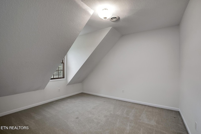 2000 Robinson Dr, Lenoir City, TN 37772 - bonus room featuring a textured ceiling, carpet, baseboards, and lofted ceiling