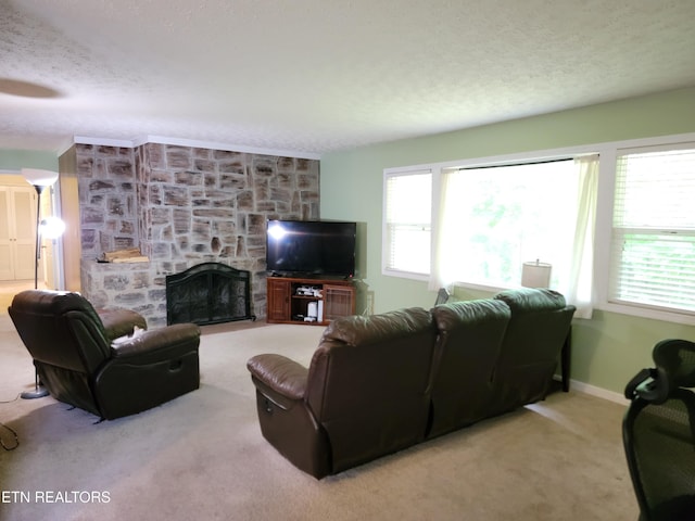 carpeted living area with baseboards, a fireplace, and a textured ceiling