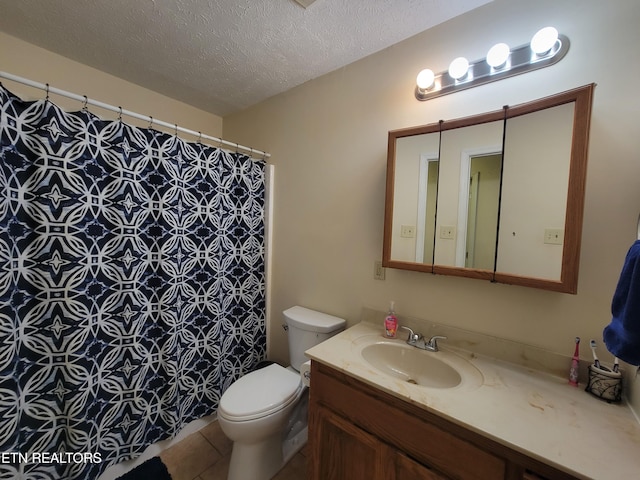 full bathroom featuring a shower with curtain, a textured ceiling, toilet, tile patterned floors, and vanity